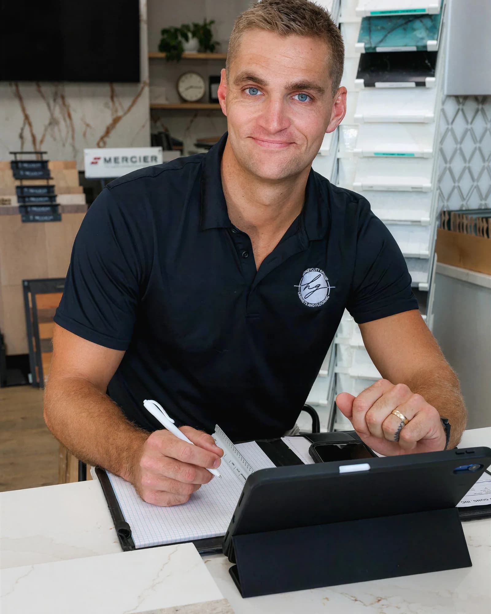Conor Honeycutt, CEO of Honeycutt Group, writing up a project plan at his showroom desk