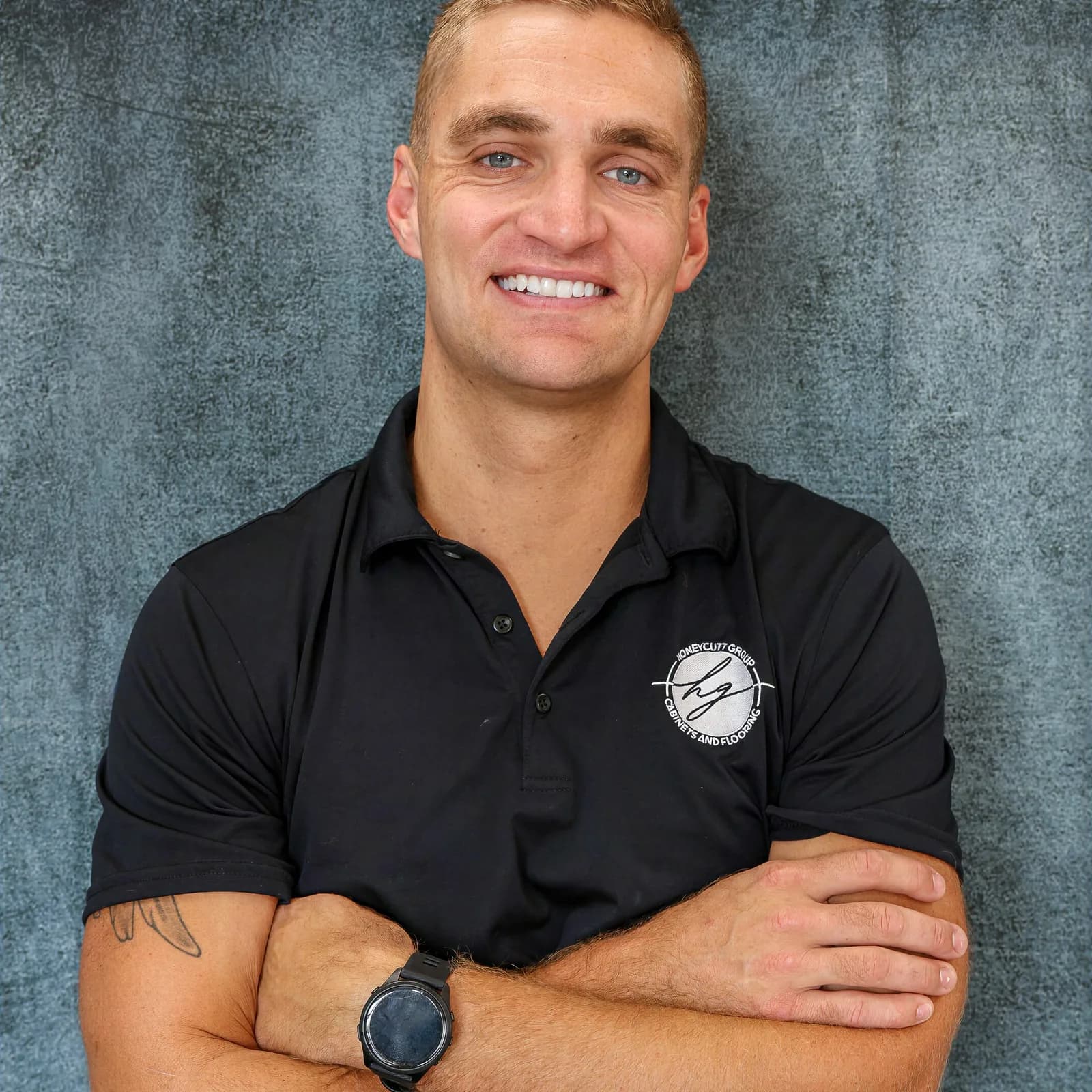 Conor Honeycutt, CEO of Honeycutt Group, smiling with arms crossed