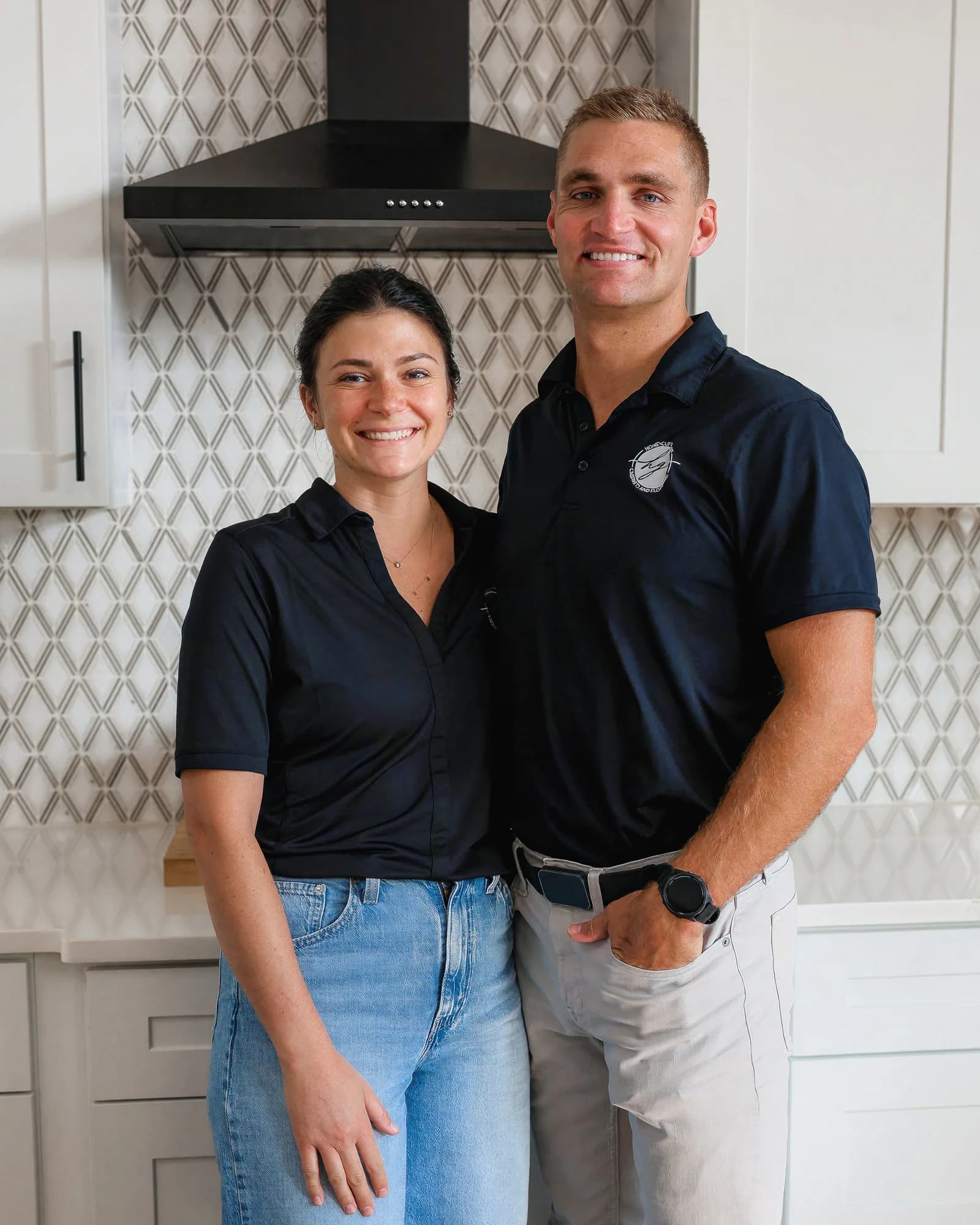 Conor and Lianna Honeycutt standing together in the Honeycutt Group showroom kitchen