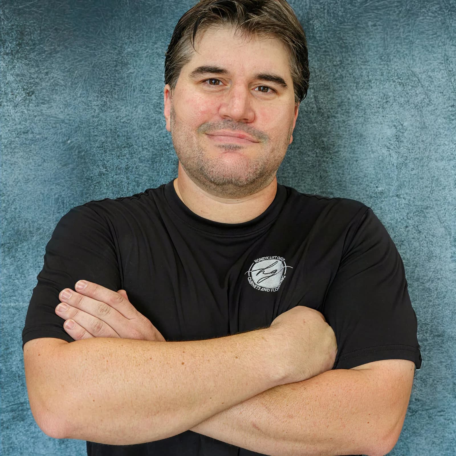 Daniel Senkowski, Operations Manager at Honeycutt Group, arms crossed