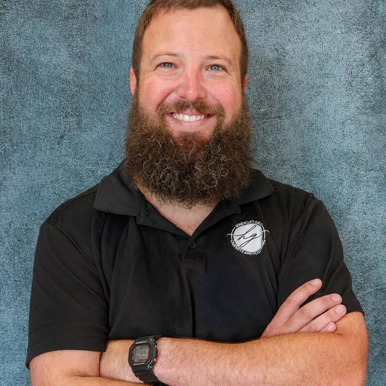 Dylan Whitley, Sales Representative at Honeycutt Group, smiling with arms crossed