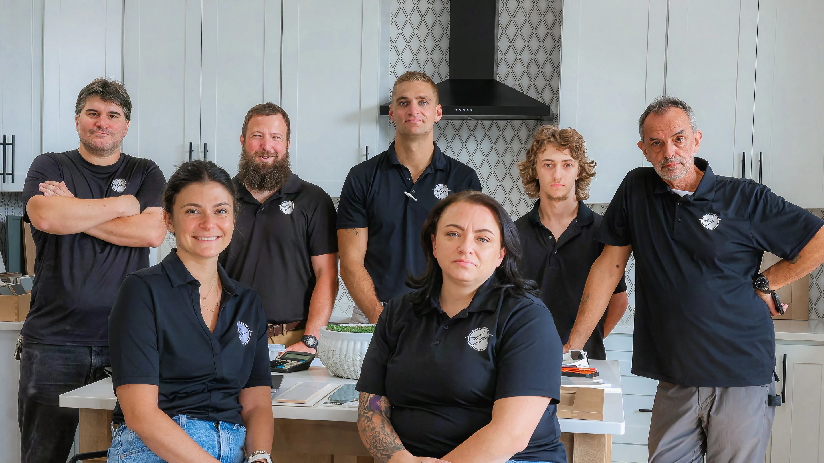 The Honeycutt Group team posing together in their Salisbury, NC showroom kitchen