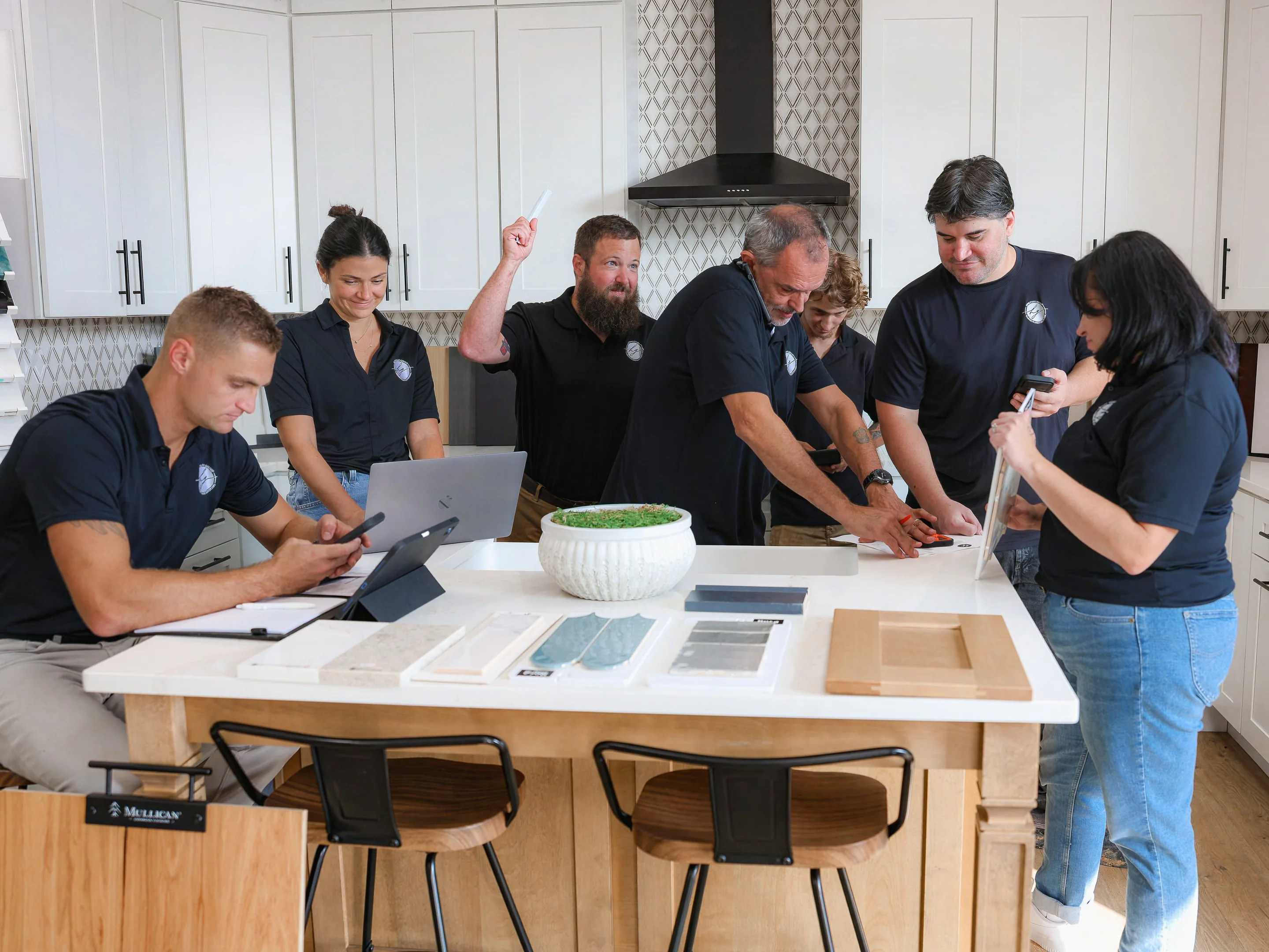 The Honeycutt Group team working together around the showroom island in Salisbury, NC