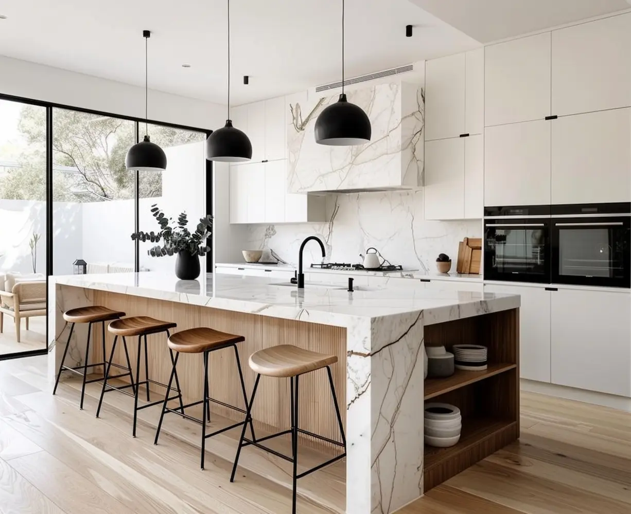 Modern kitchen with marble island, wood bar stools, black pendant lights, and white cabinetry