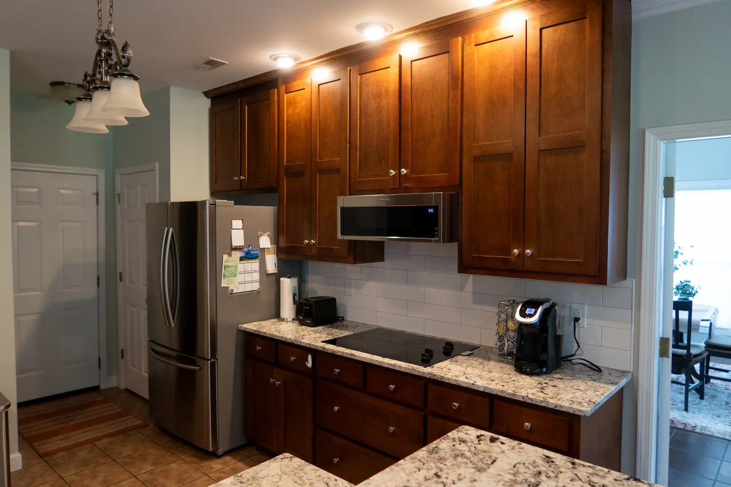 Cherry cabinets with granite counters and stainless refrigerator
