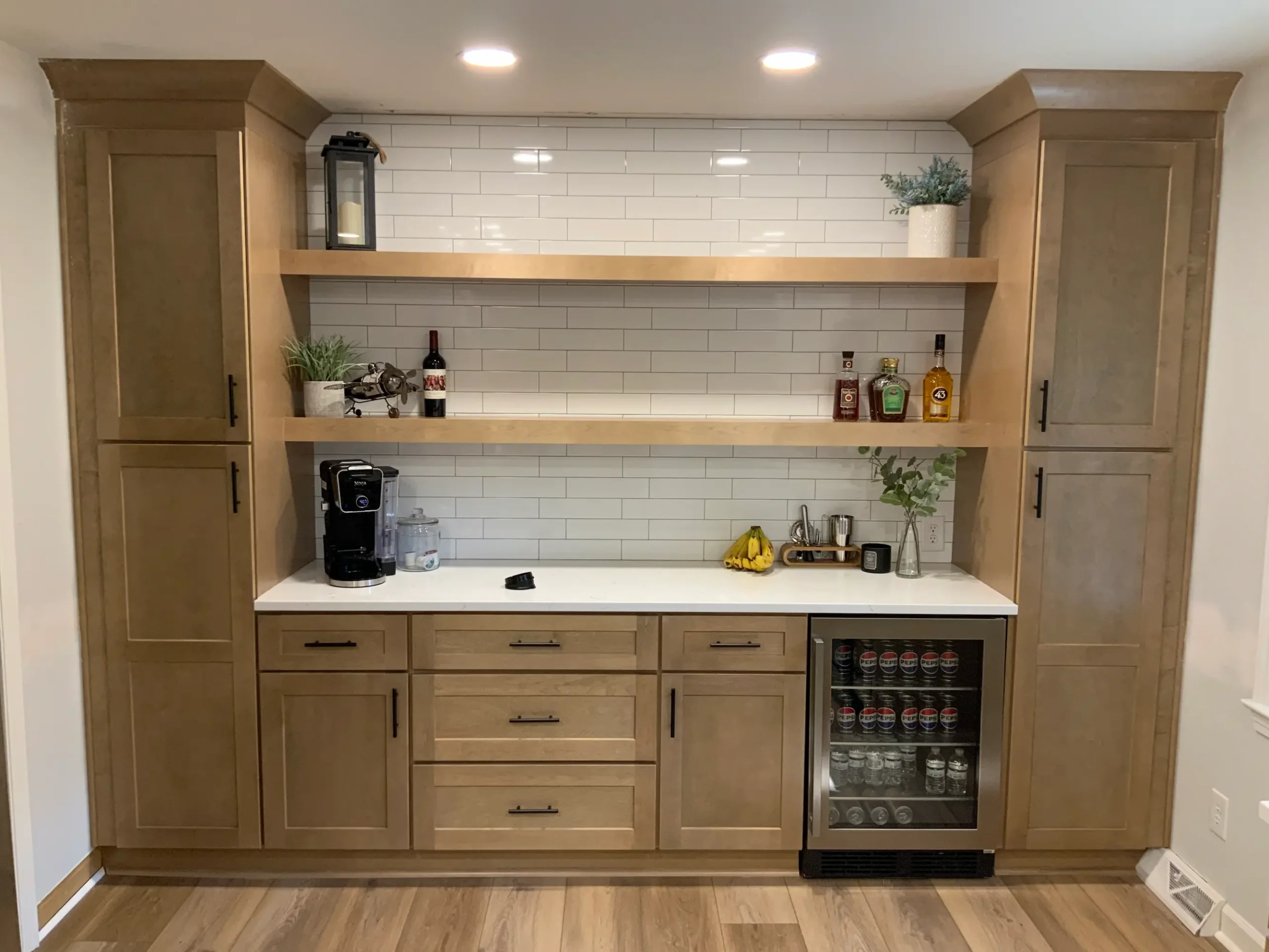 Wood coffee bar with floating shelves and a beverage fridge