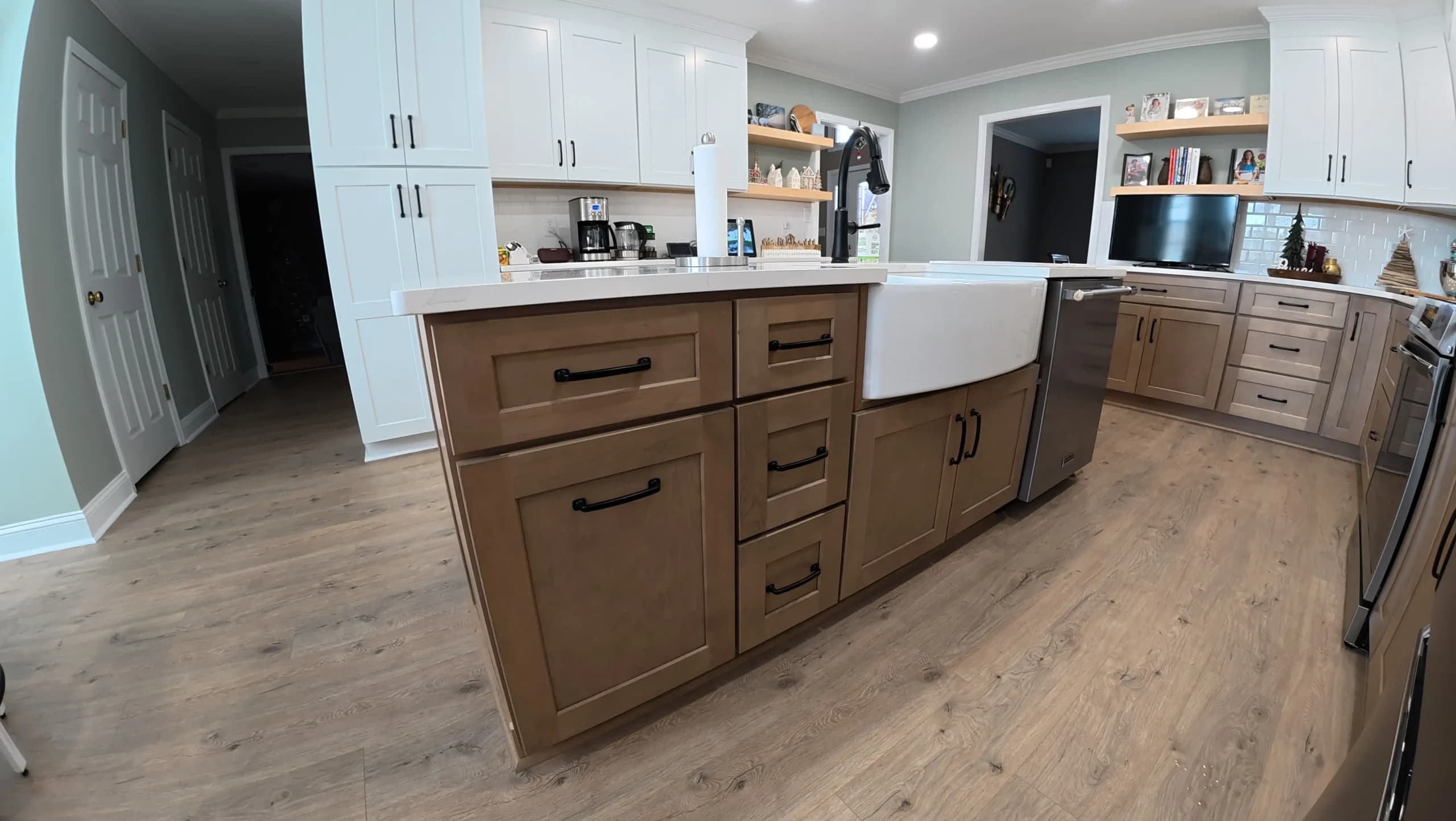 Walnut base cabinets with farmhouse sink and white quartz counters