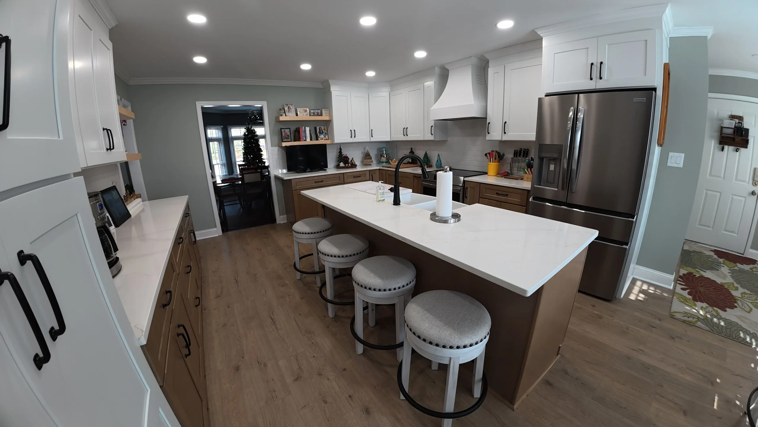 Kitchen island with counter stools under recessed lighting