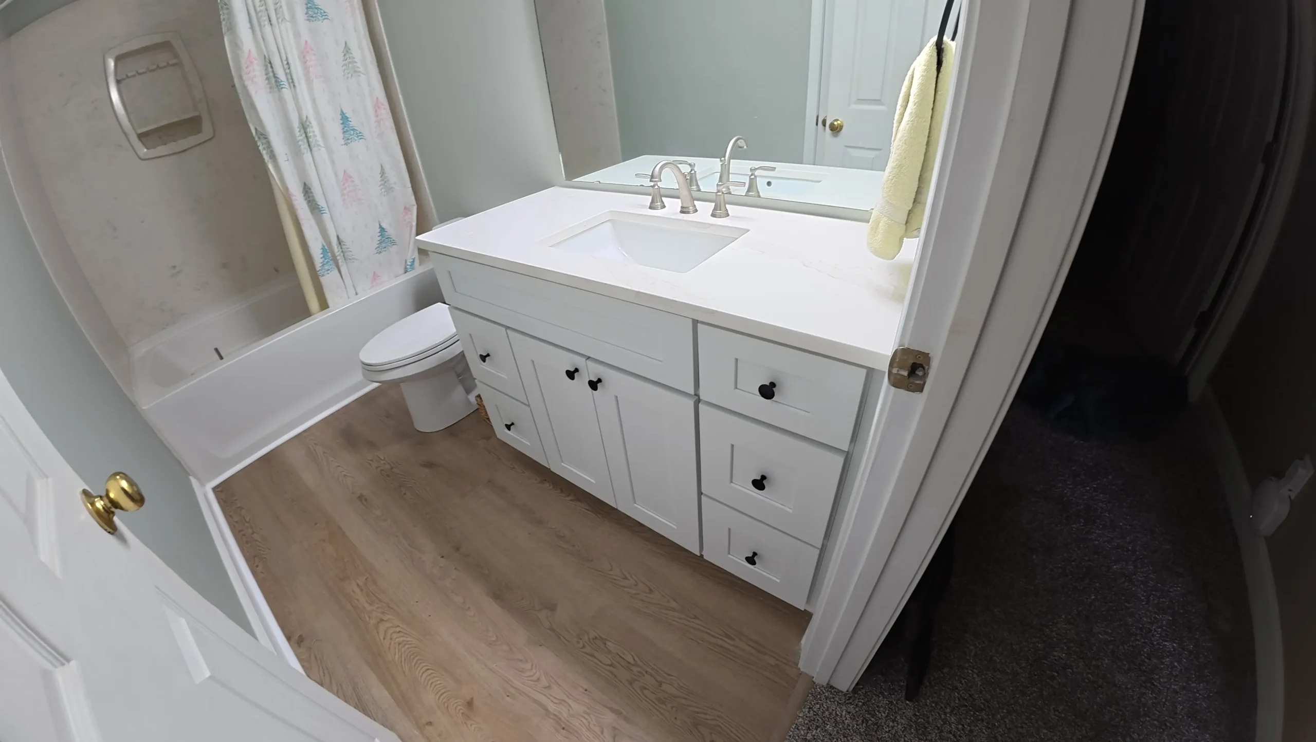 Bathroom with white vanity, bathtub and tiled flooring
