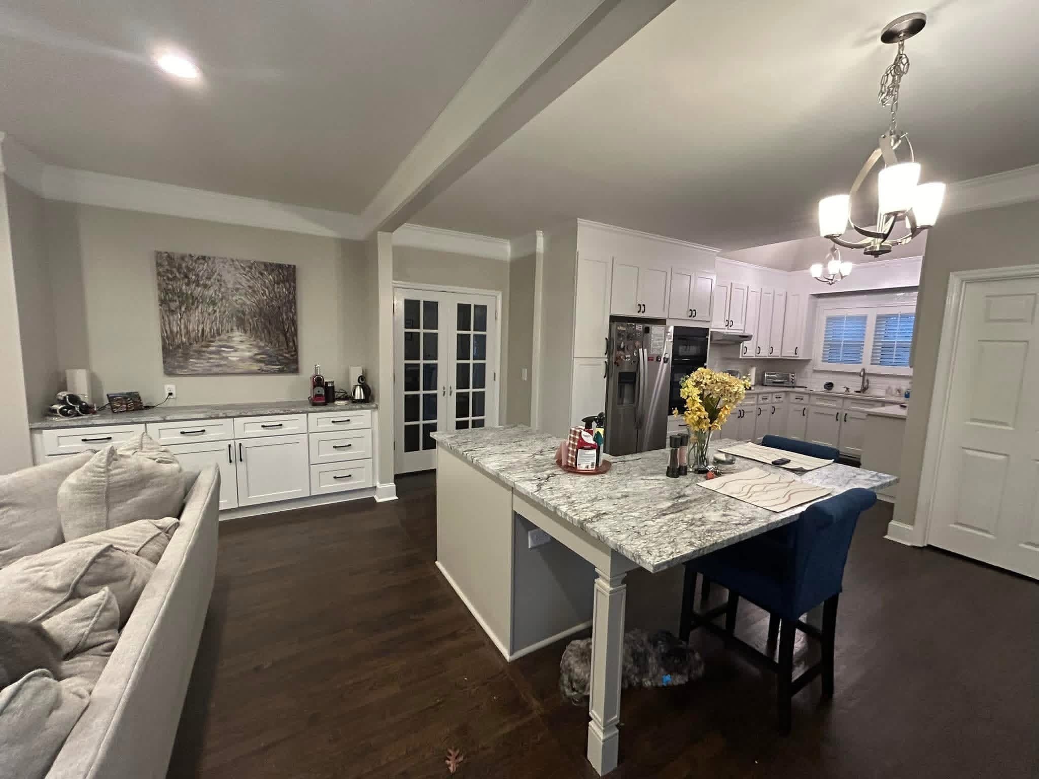 Open kitchen and living area with granite island and blue stools