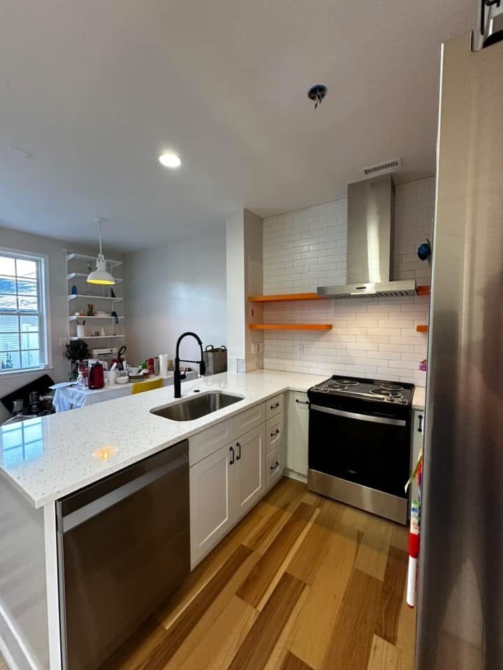Clean and classic kitchen remodel with contemporary finishes and layout