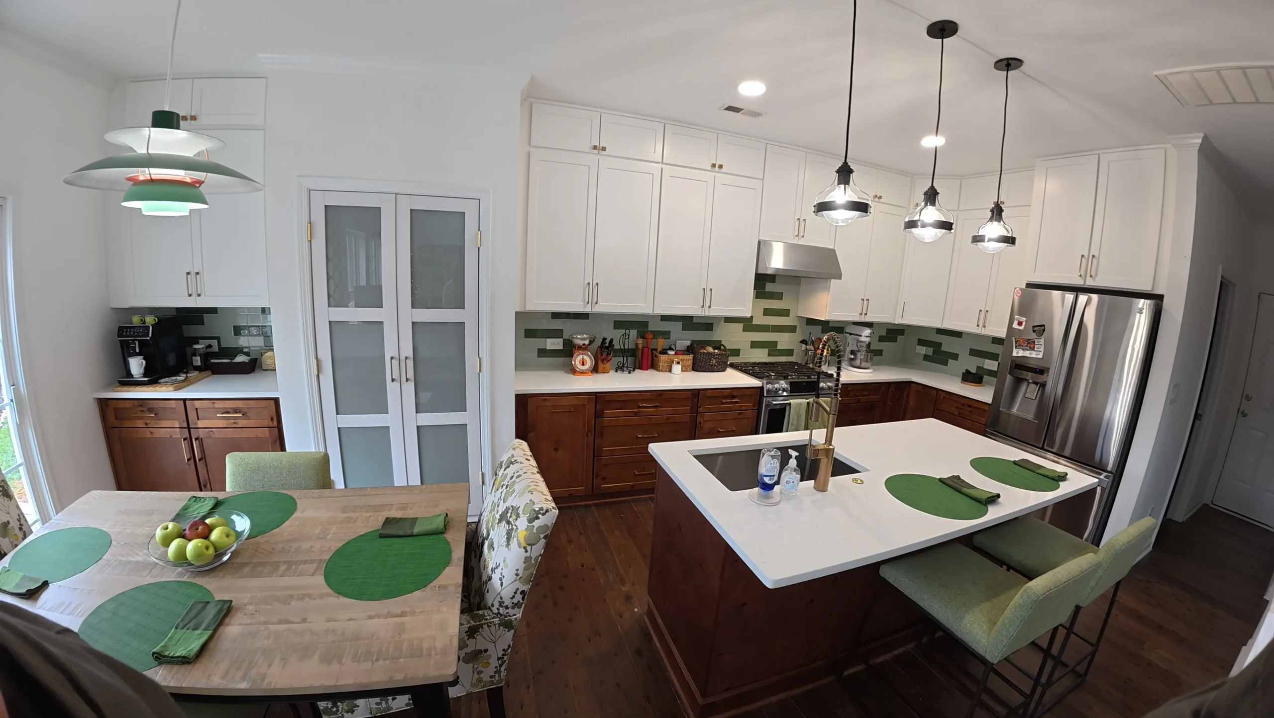 Open kitchen and dining space with pendant lights over the island