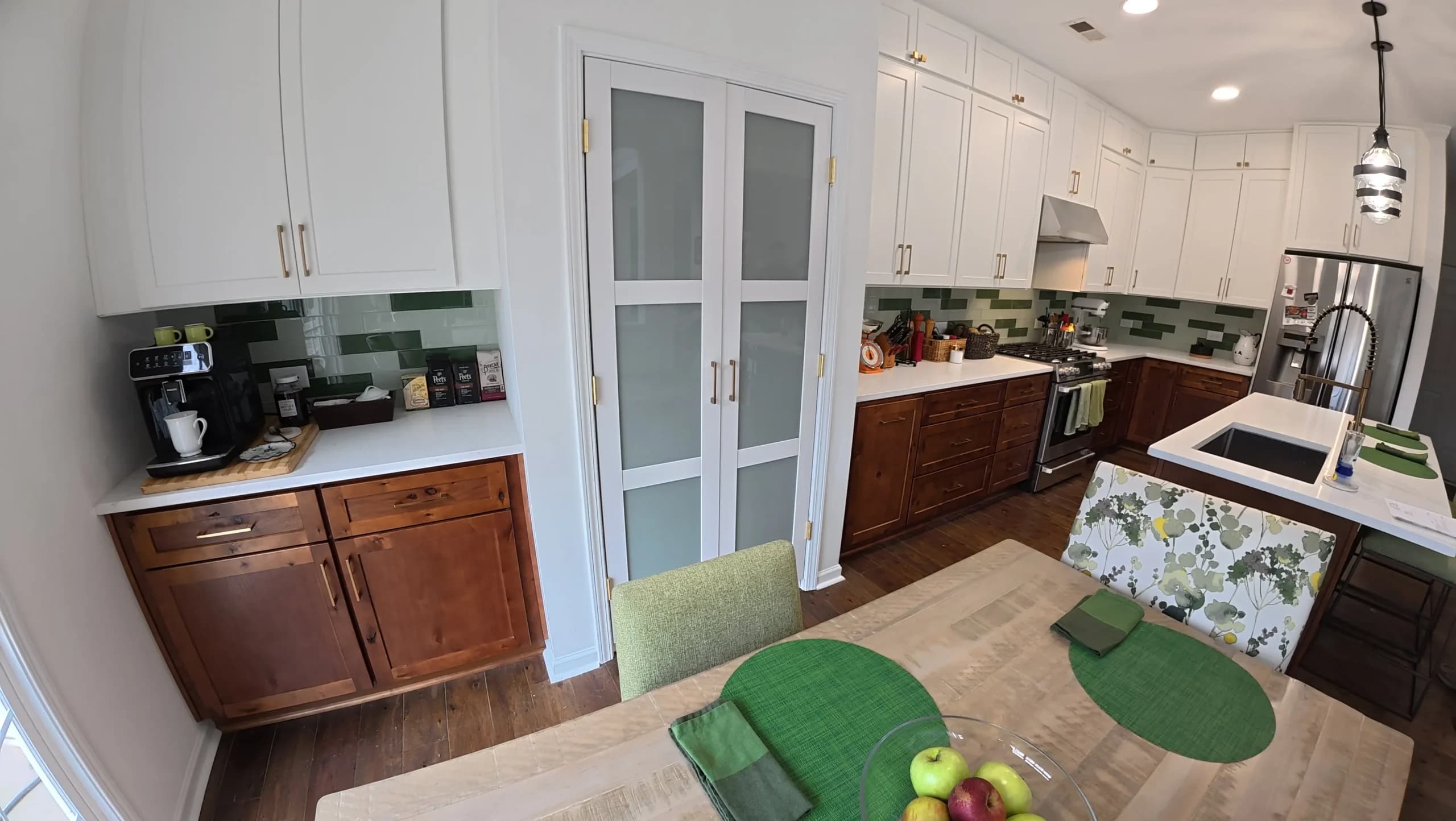Kitchen and dining area with glass-front pantry doors