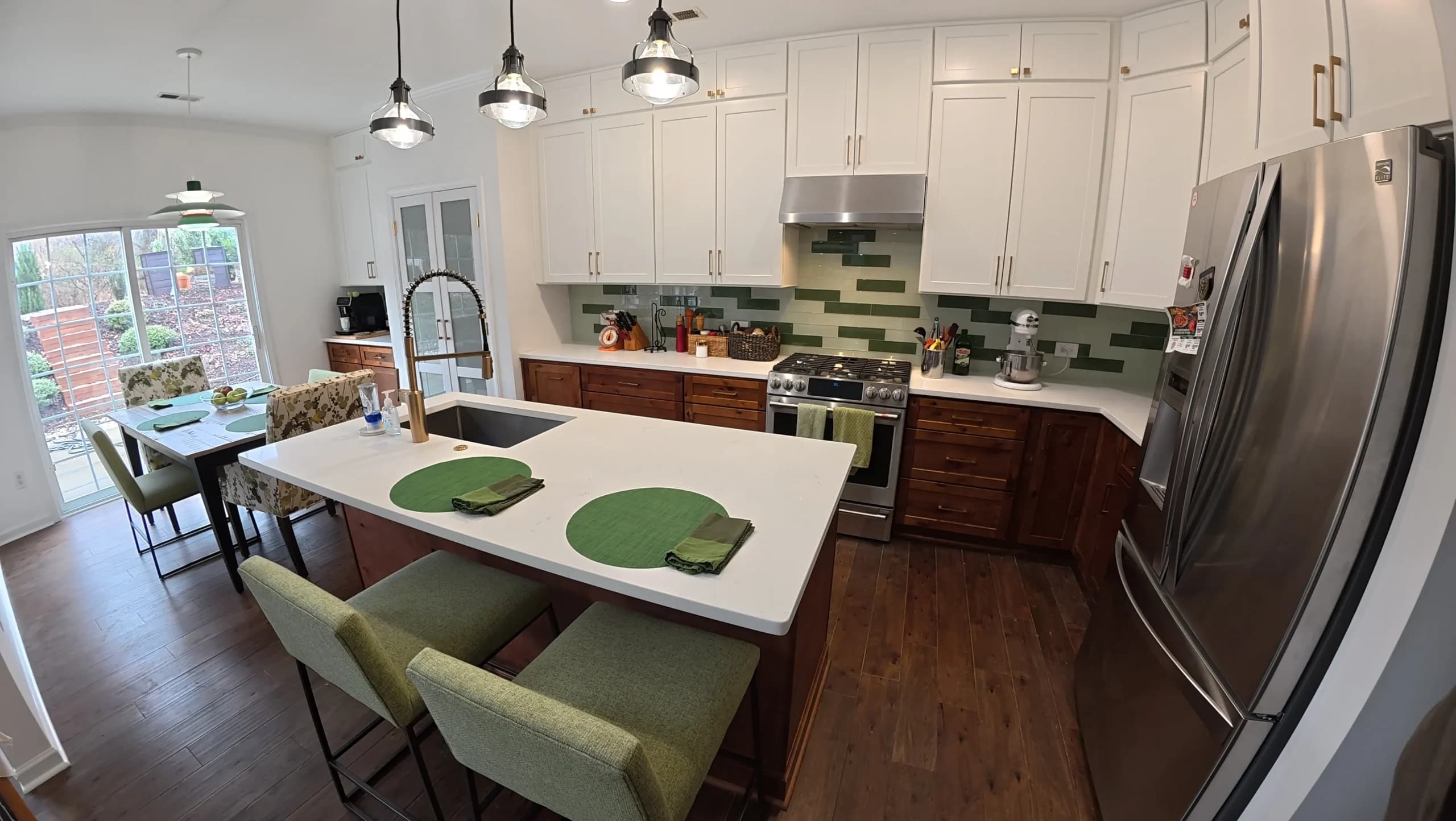 Two-tone kitchen island with pendant lights and counter seating