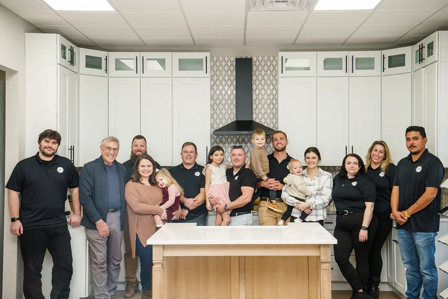 The Honeycutt Group crew and their families in the Salisbury showroom kitchen